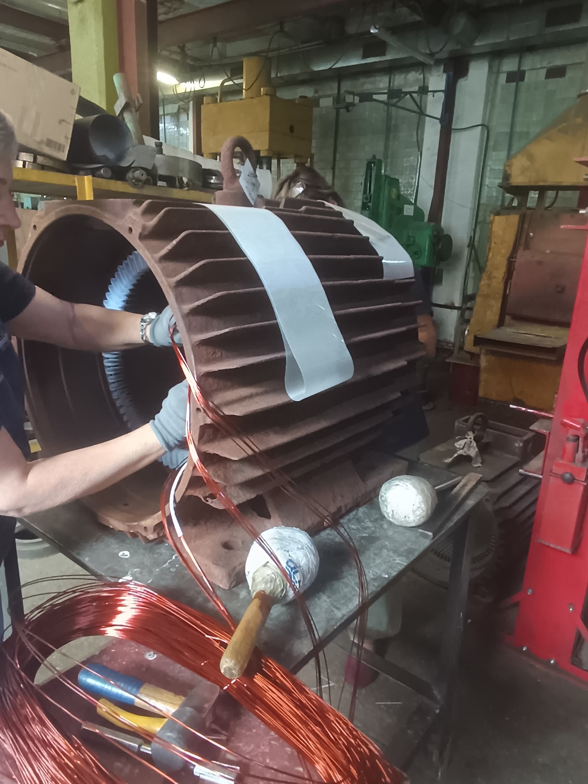 Stator winding being inserted in the winding shop